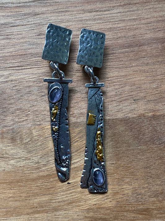 Modern abstract dangling hammered silver and gold coloured clip on earrings with purple accents