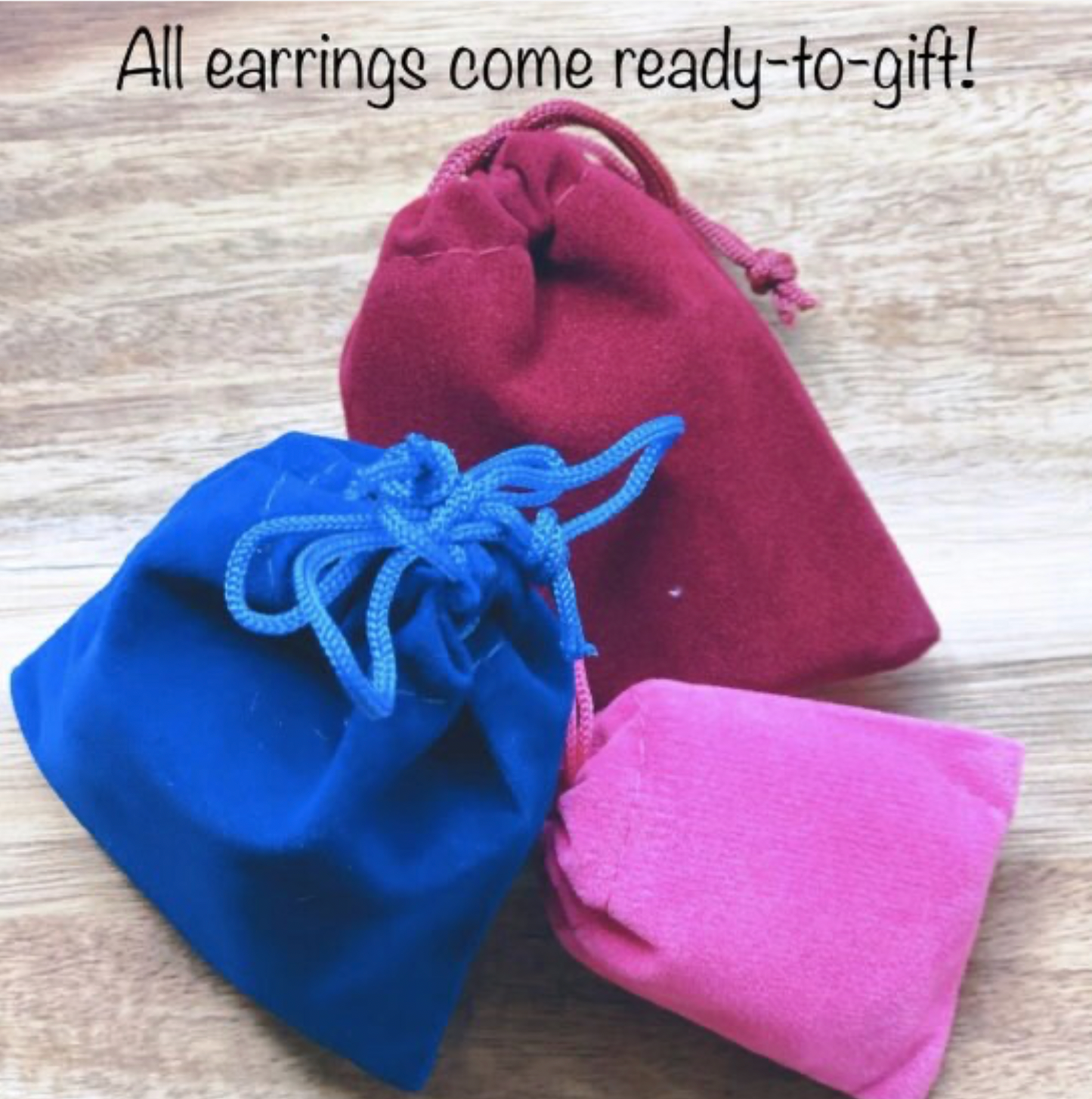 three small pouches sitting on top of a wooden table