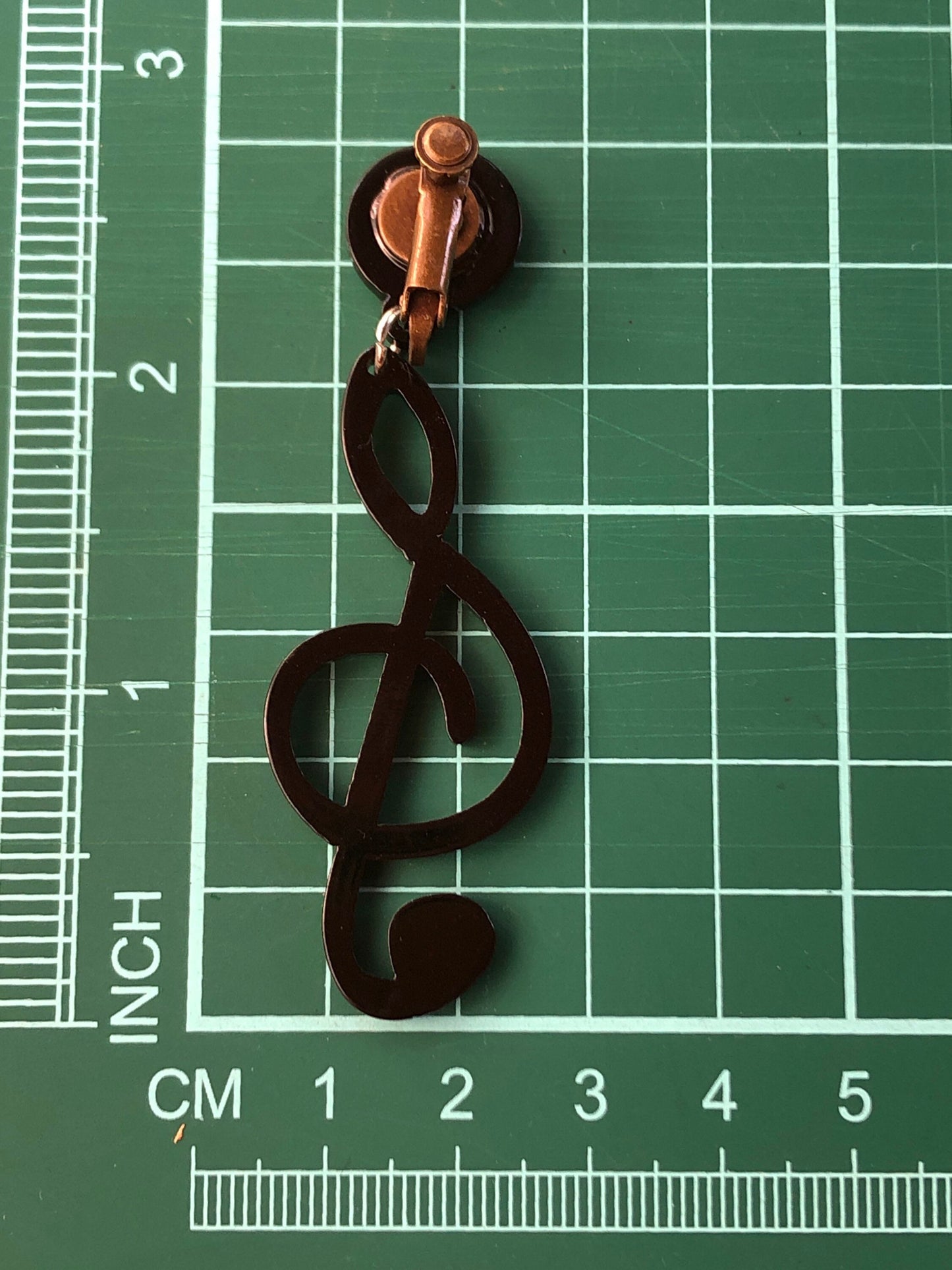 Dangling oversized black plastic treble clef clip on earrings