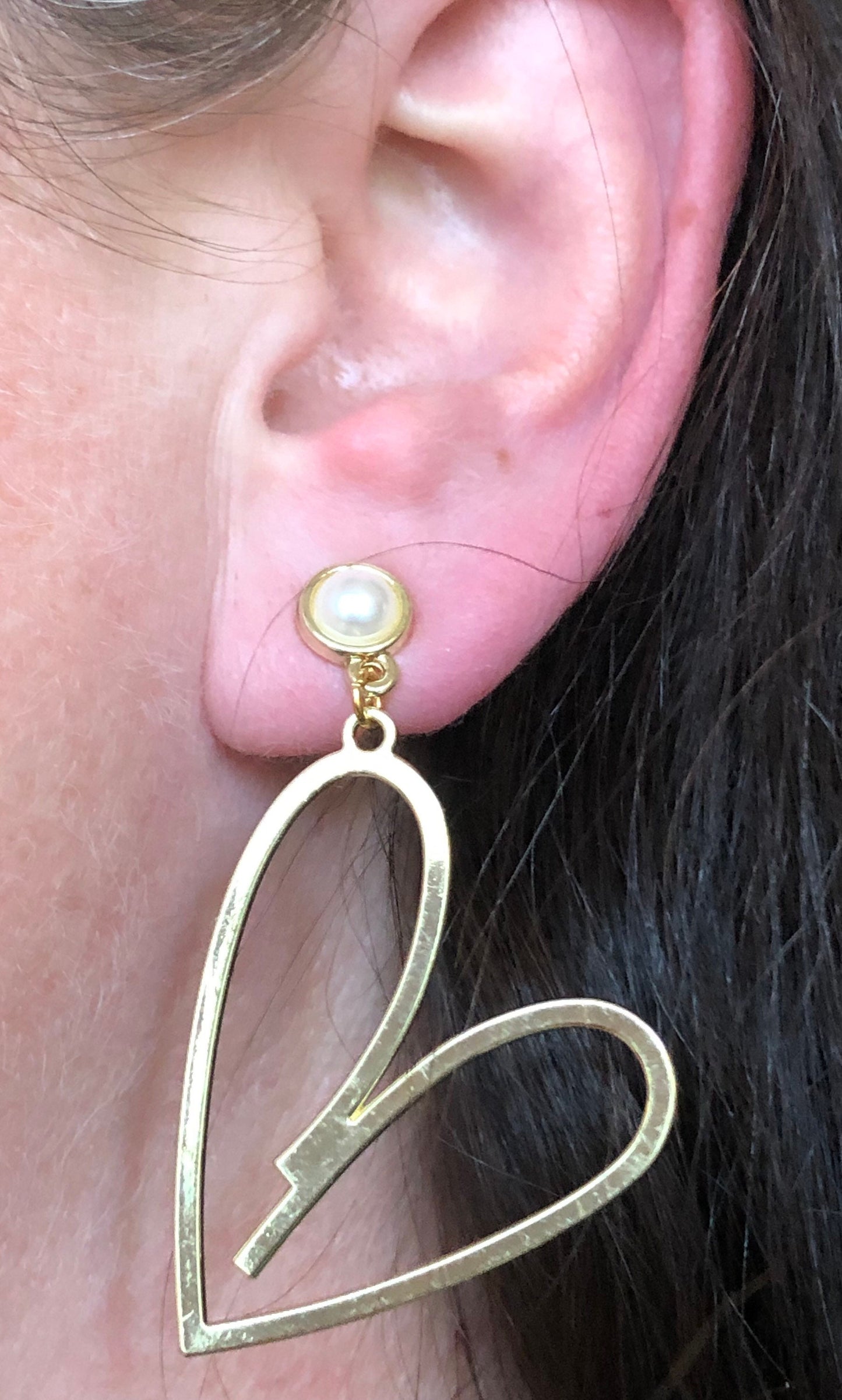 Large clip on dangling gold heart silhouette earrings with faux pearl closures