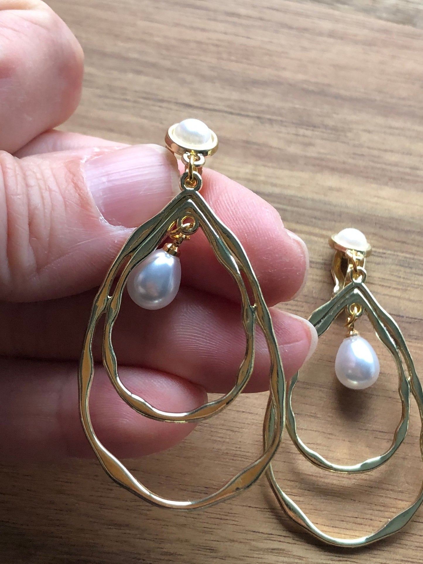 Dangling gold hoops with faux pearls clip on earrings