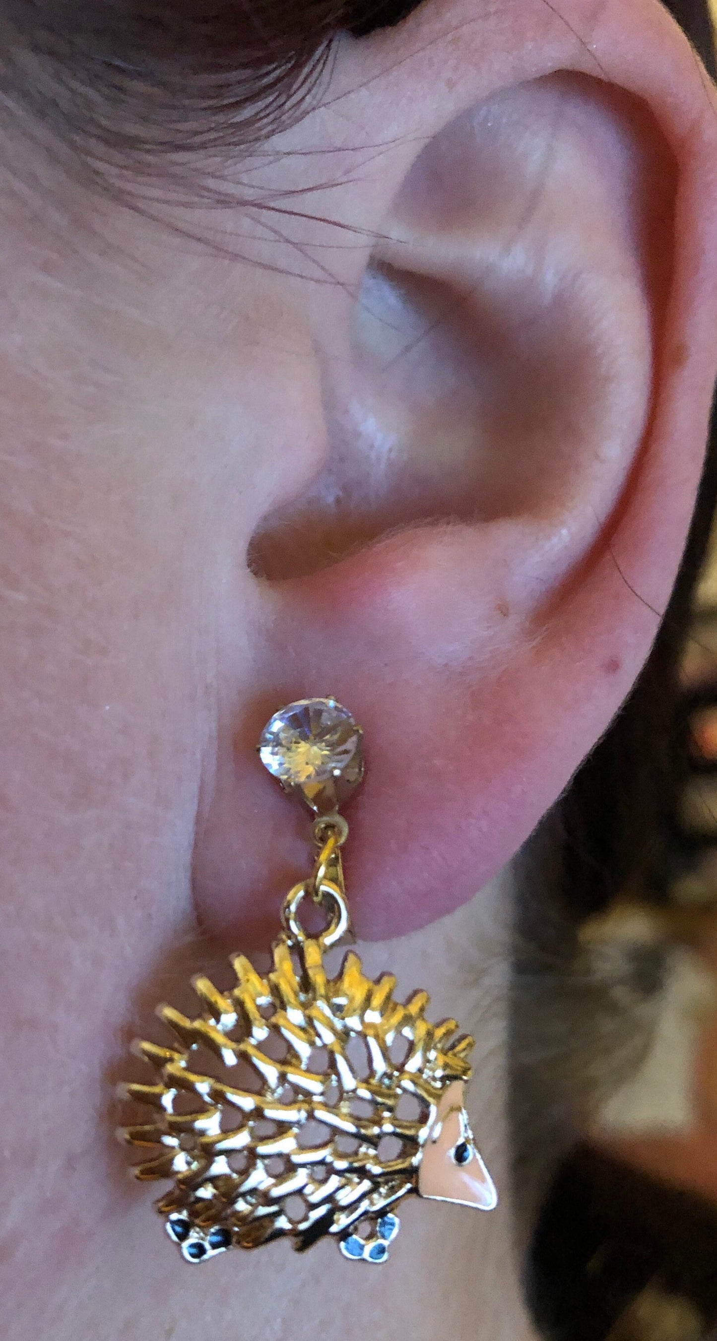 Dangling golden hedgehog clip on earrings