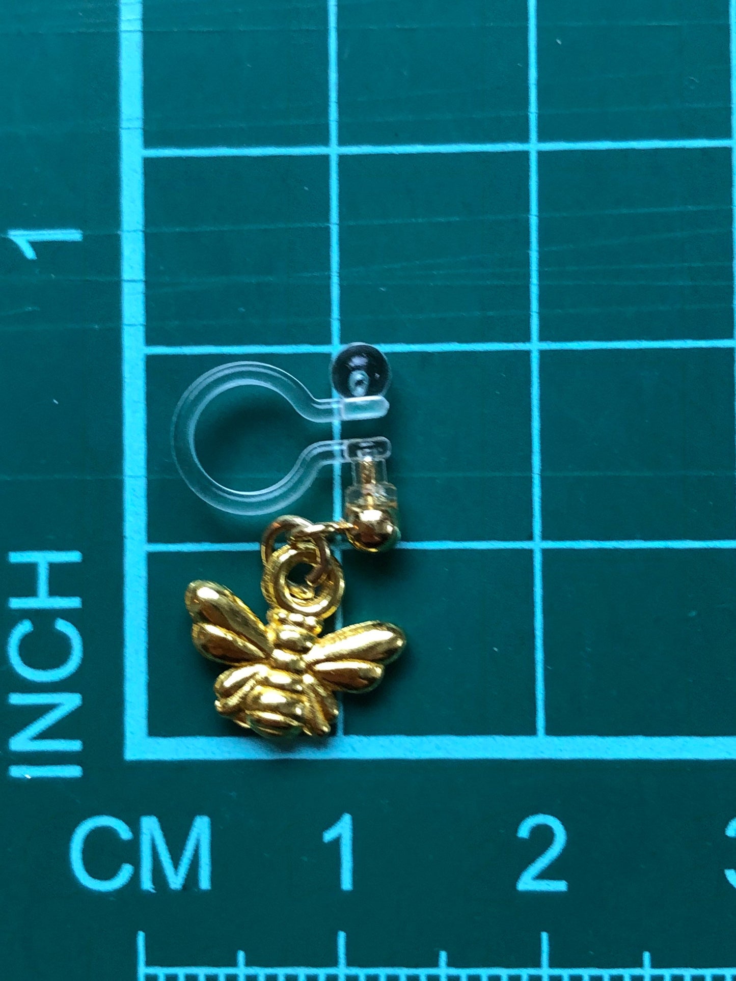 Dangling invisible clip on earrings (no piercing no pierce) with tiny golden bumblebee pendants