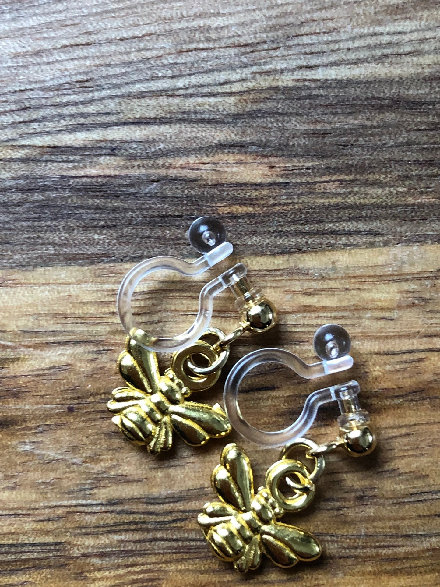 Dangling invisible clip on earrings (no piercing no pierce) with tiny golden bumblebee pendants