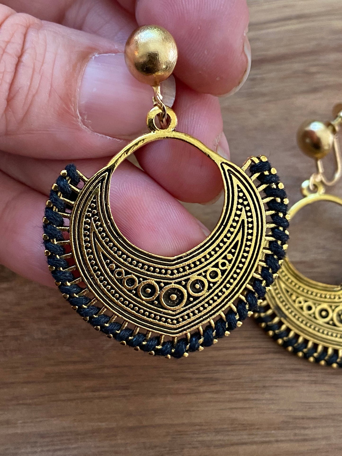 Dangling golden hoop clip on earrings with black accents