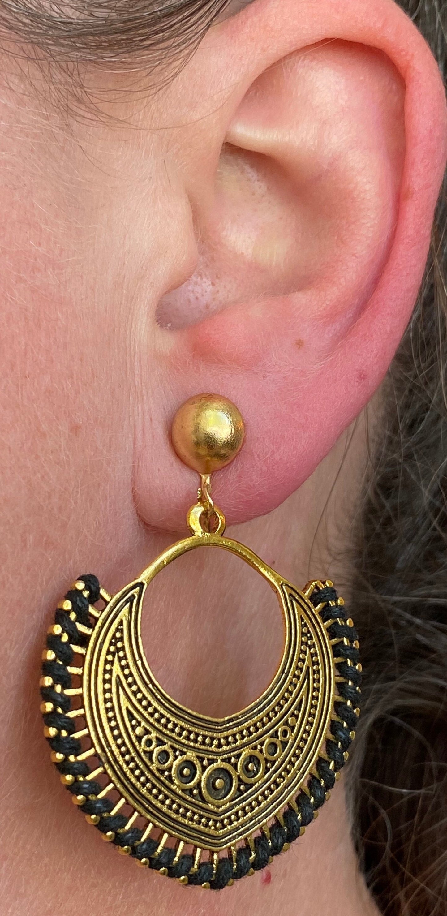 Dangling golden hoop clip on earrings with black accents