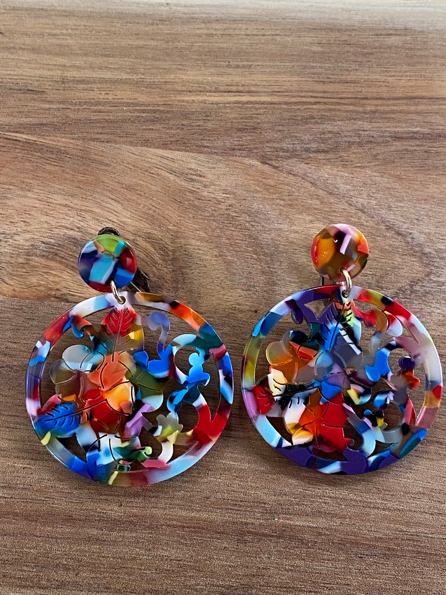 Dangling round carved rainbow acetate clip on earrings, multicoloured plastic screwback earrings