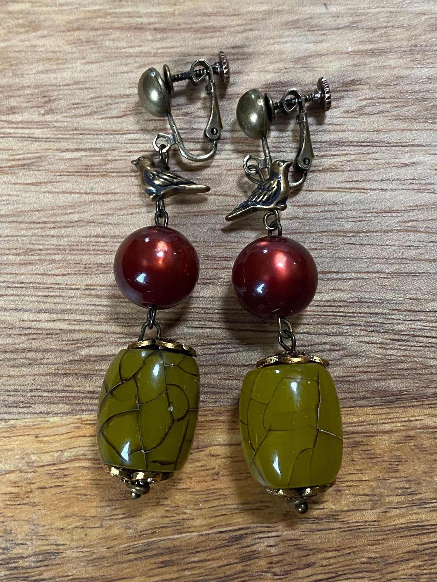 Gorgeous dangling  beaded clip on earrings, green and red beads with bronze bird accent, screwback bird earrings, ooak