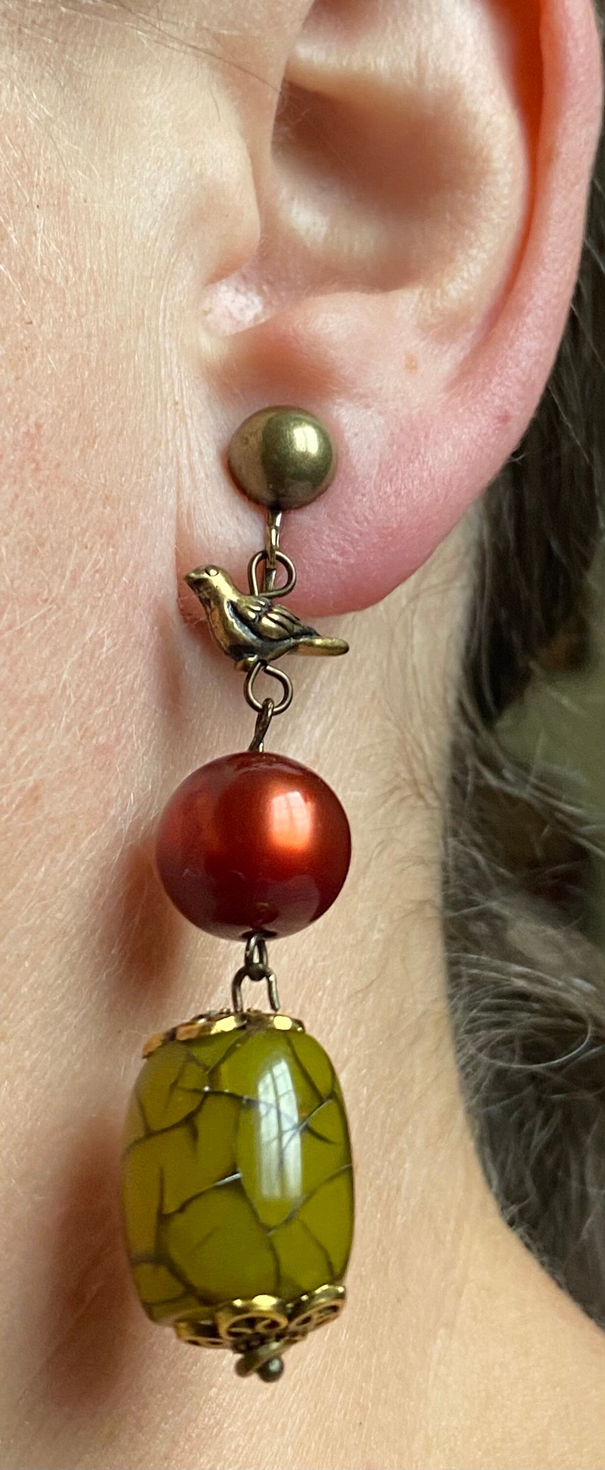 Gorgeous dangling  beaded clip on earrings, green and red beads with bronze bird accent, screwback bird earrings, ooak