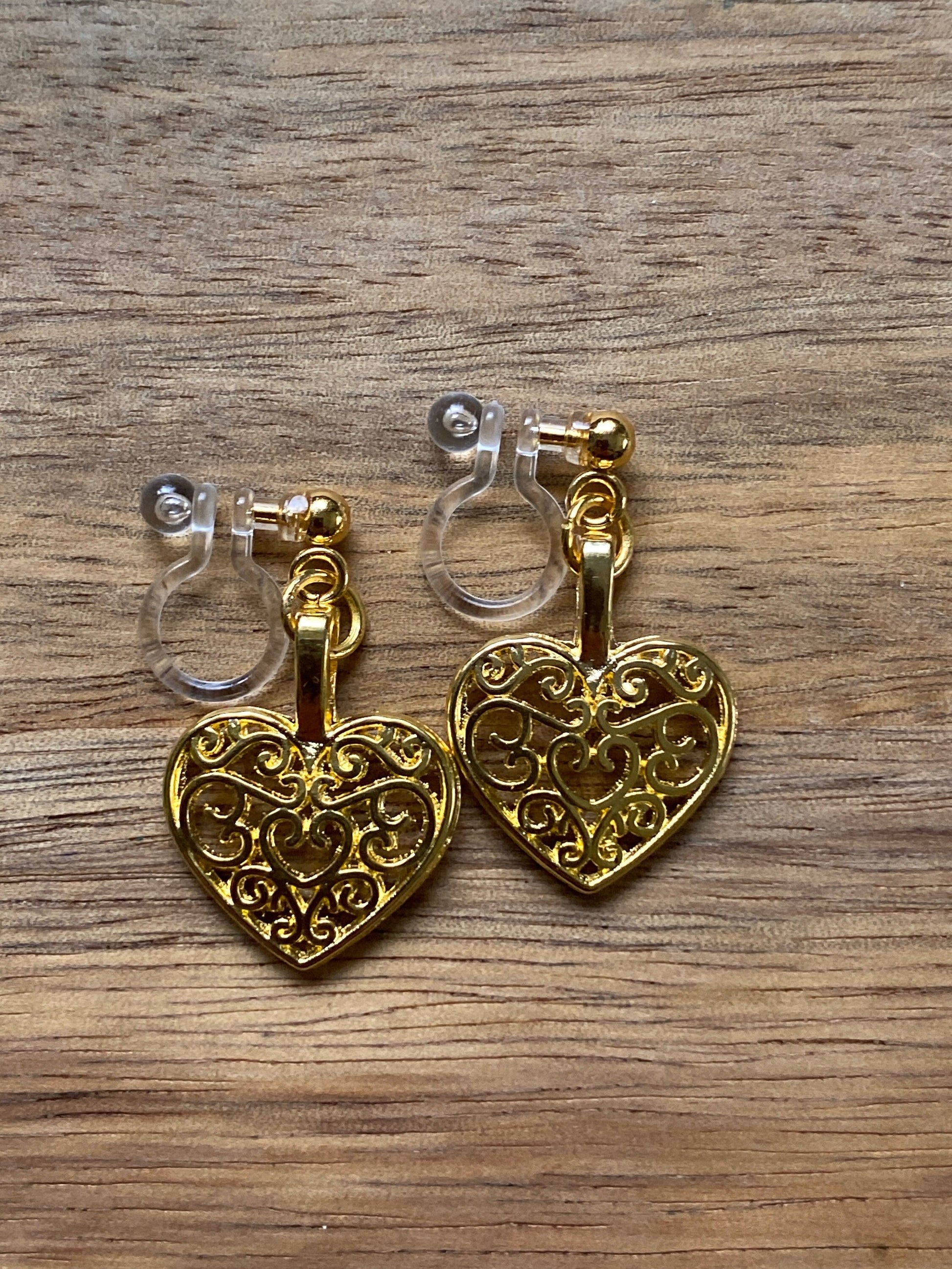 dangling golden heart clip on earrings. invisible clip on earrings