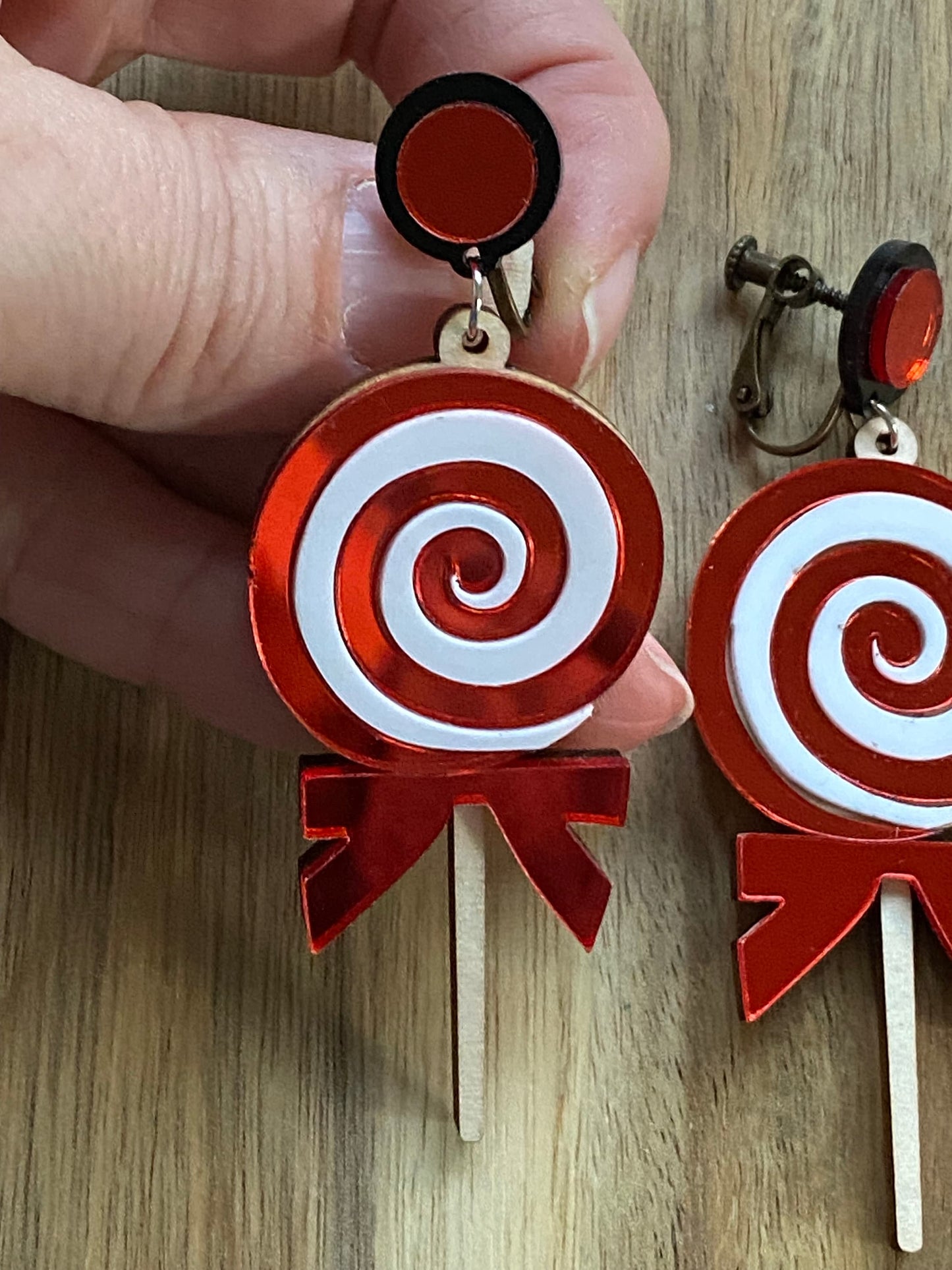 Dangling Christmas candy clip on earrings, giant plastic lollipop earrings with hinged screwback closures.