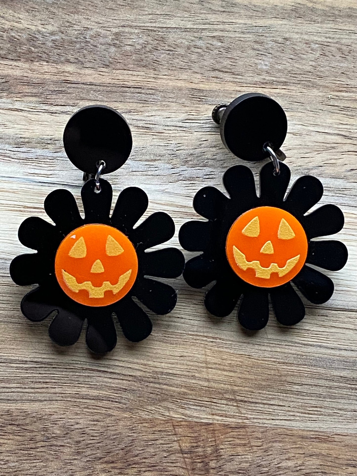 Dangling clip on earrings, Halloween black and orange daisies