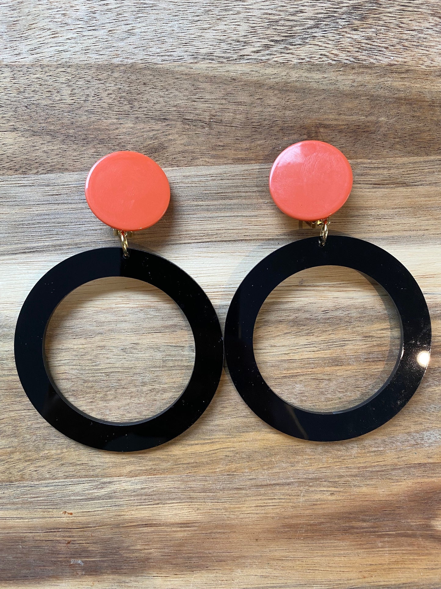 Giant modern clip on drop  plastic hoop earrings, black and tangerine hoops