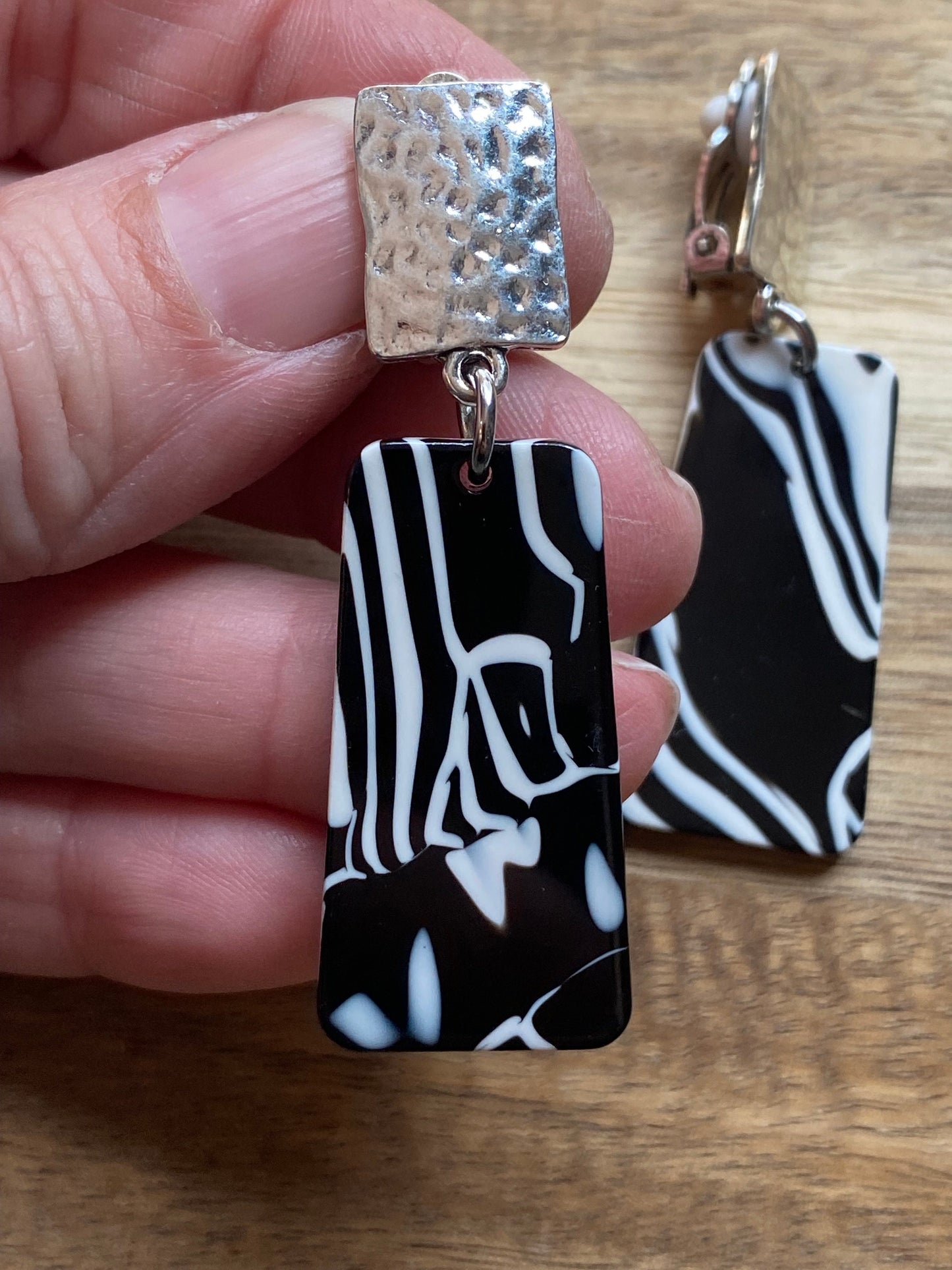 Dangling clip on plastic black and white marbled trapezoid earrings