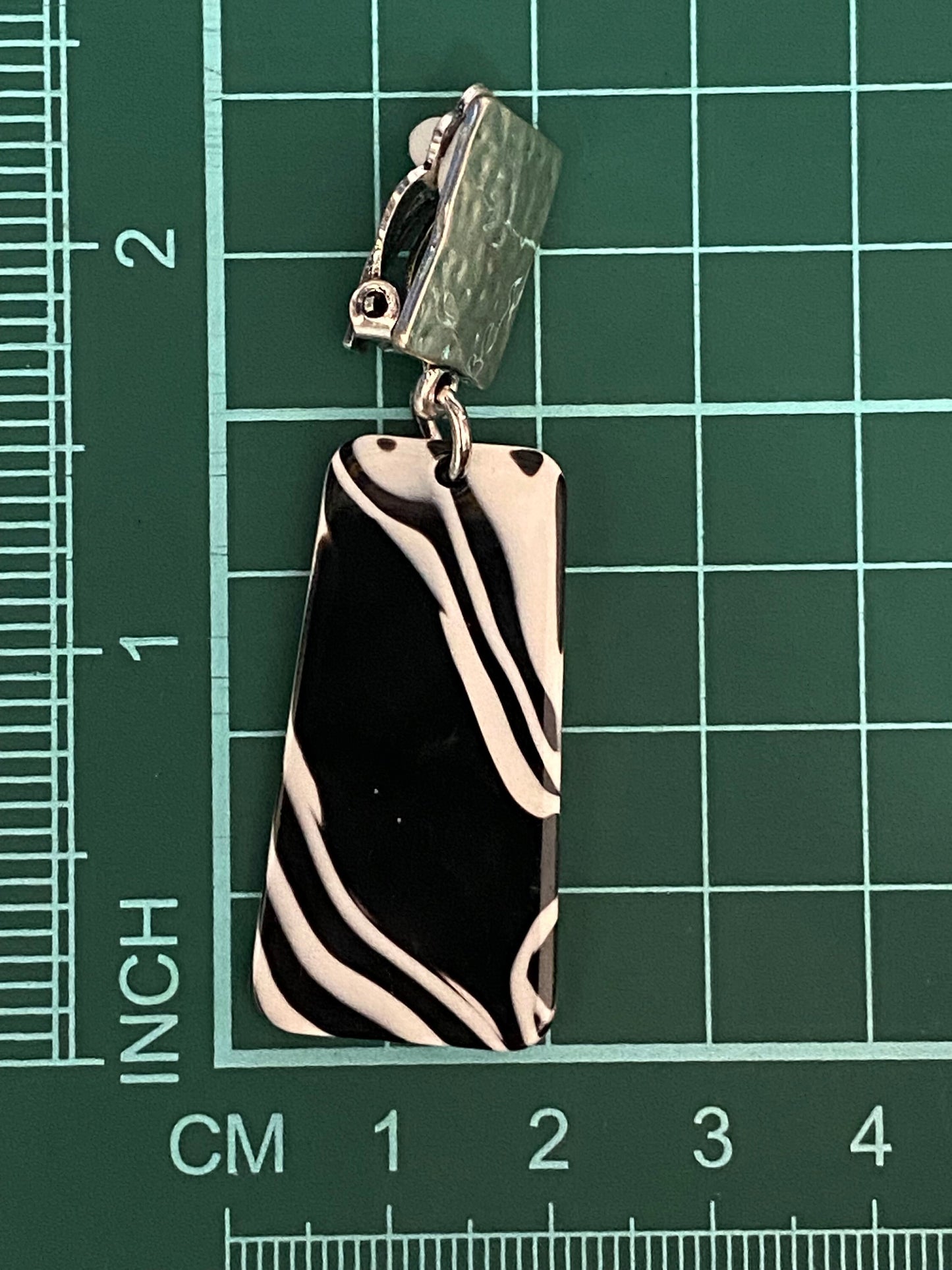 Dangling clip on plastic black and white marbled trapezoid earrings