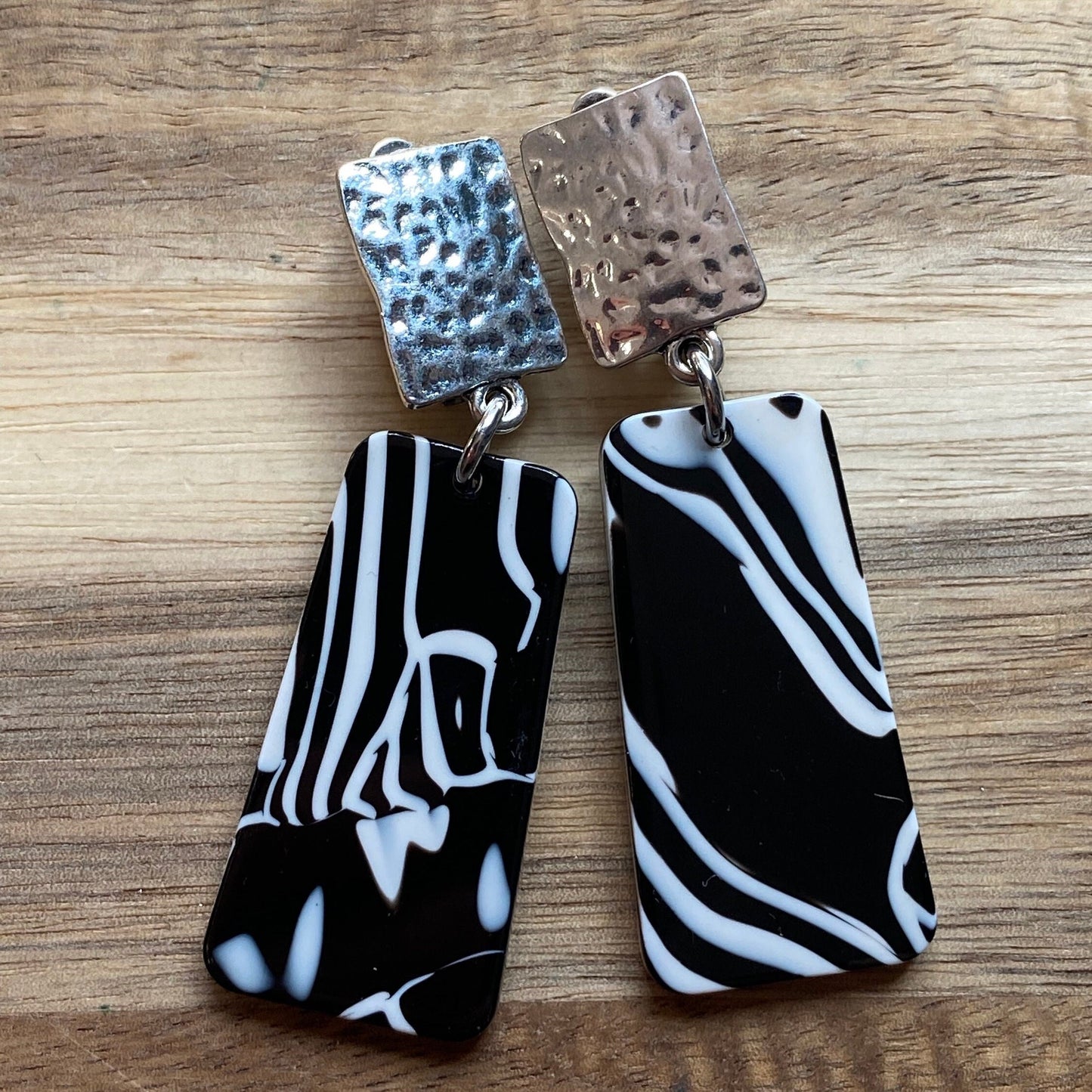 Dangling clip on plastic black and white marbled trapezoid earrings