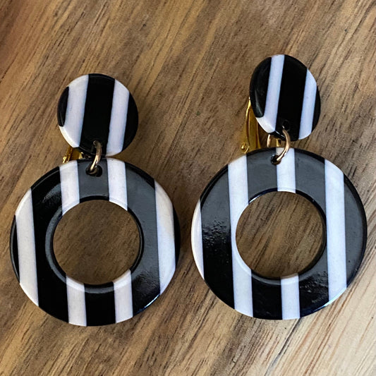 Dangling black and white striped plastic hoop clip on earrings