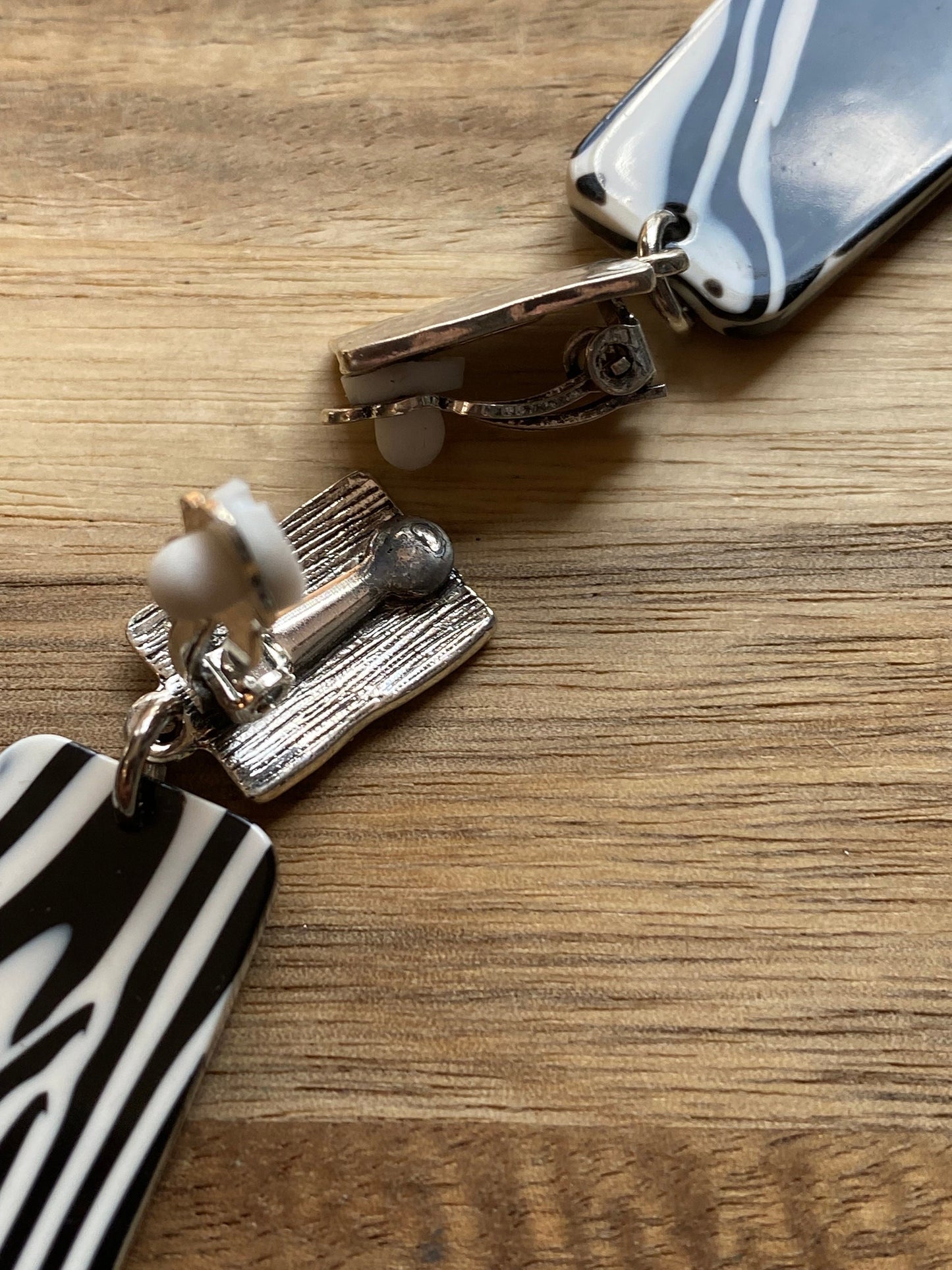 Dangling clip on plastic black and white marbled trapezoid earrings