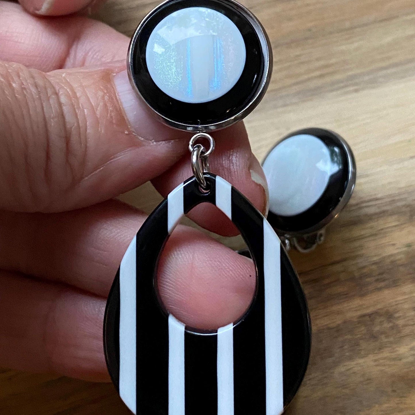 Dangling black and white striped plastic teardrop hoop clip on earrings