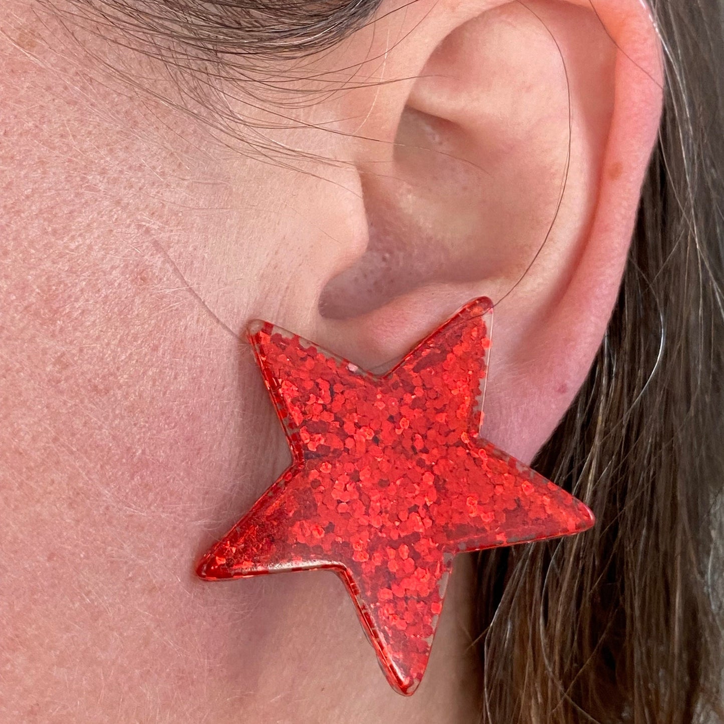 Big chunky plastic glitter clip on red star earrings