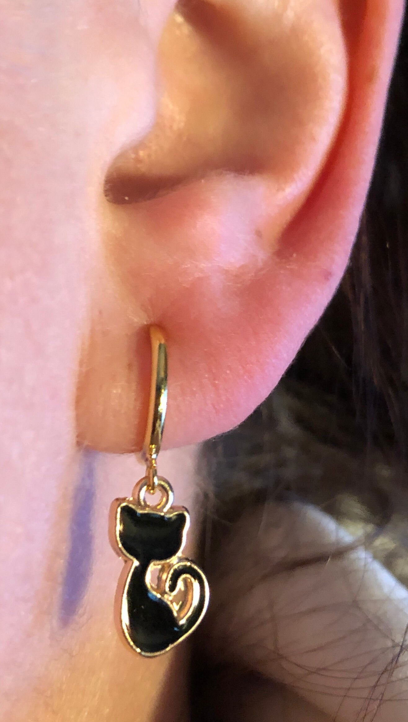 a close up of a person wearing a pair of earrings