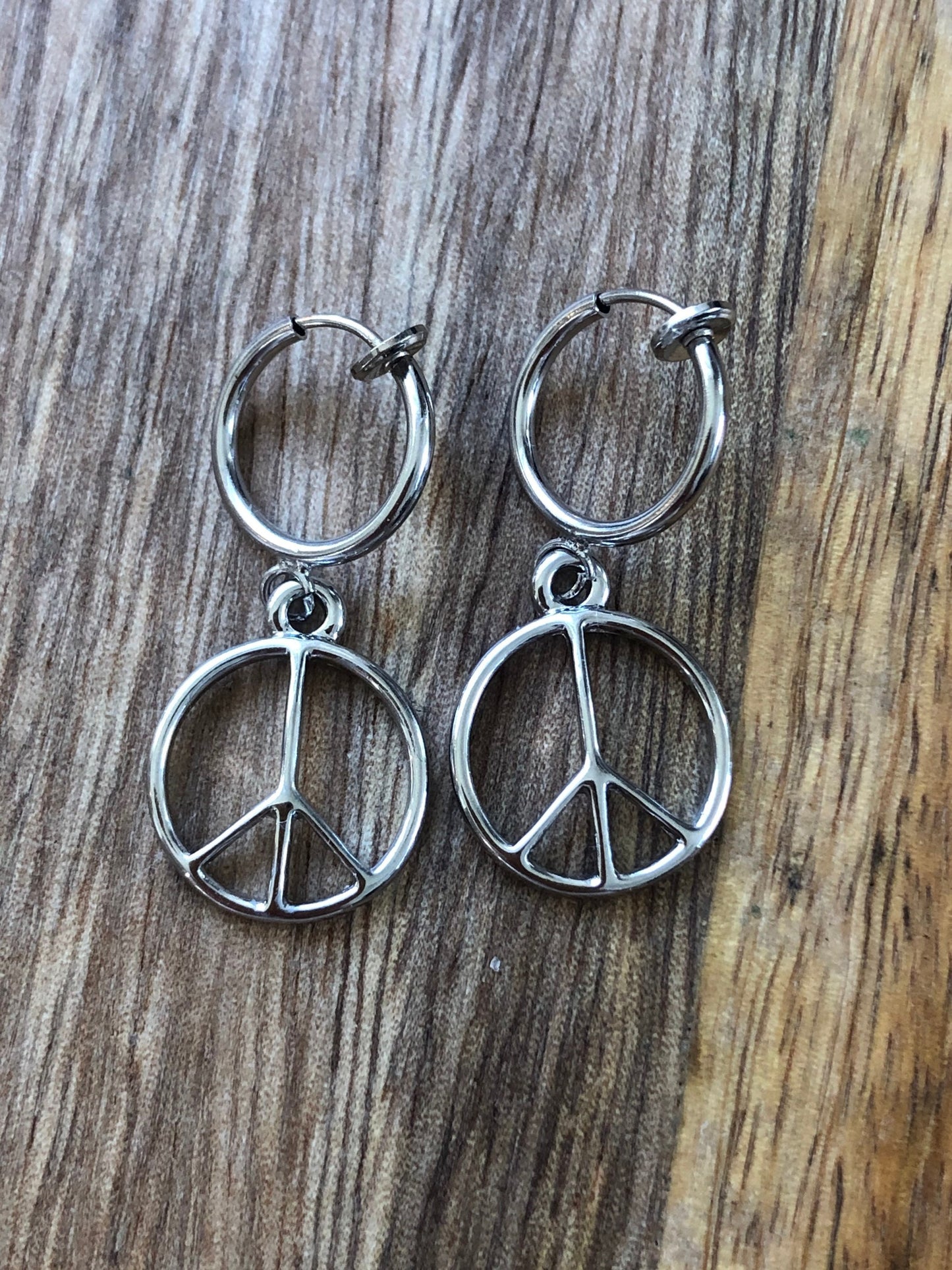 Silver coloured clip on earrings dangling charms on spring hoops (hearts, peace, fox, spider)