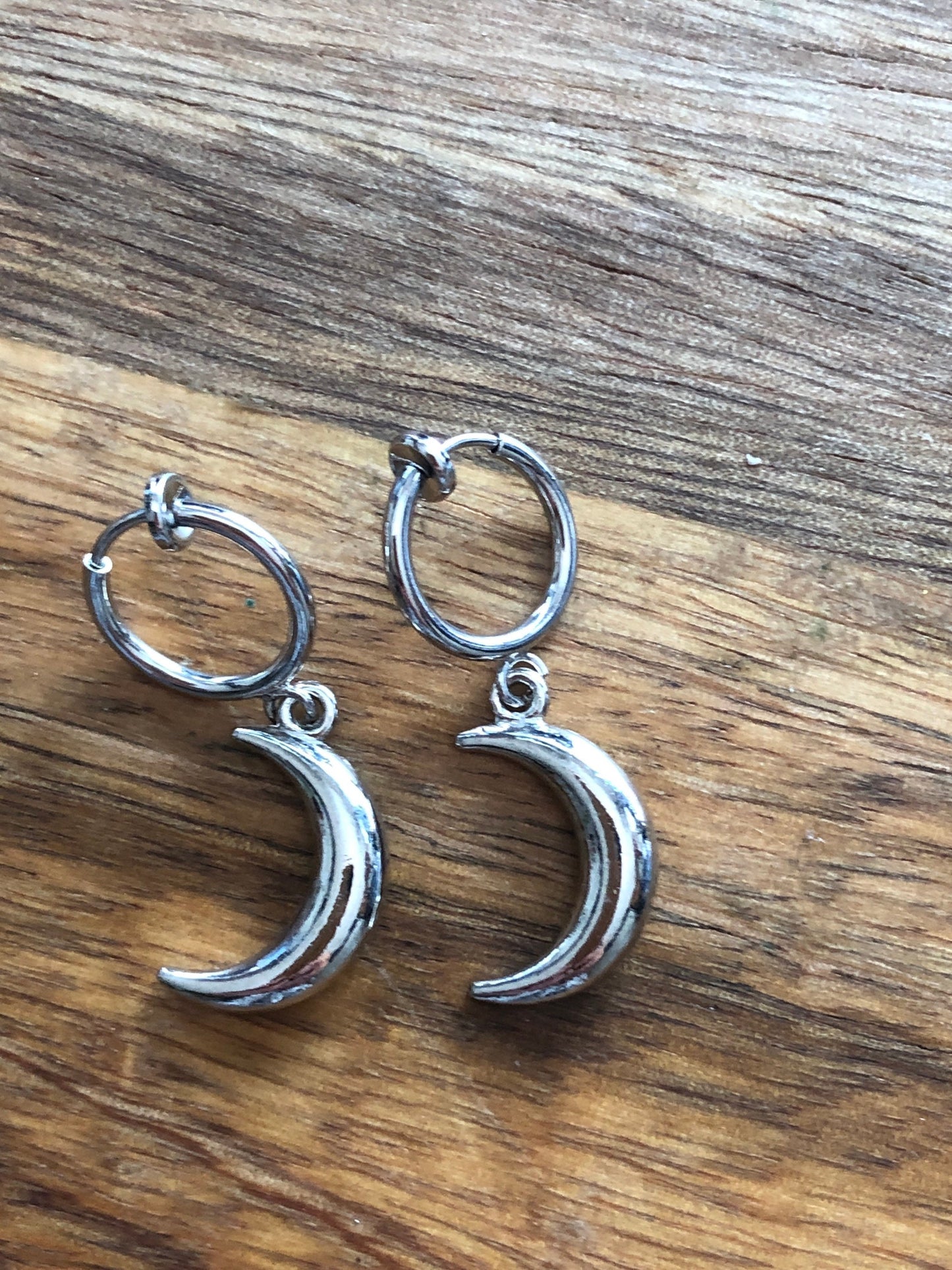 Dangling silver, bronze or gold coloured crescent moon spring hoop (huggie) or clip on earrings