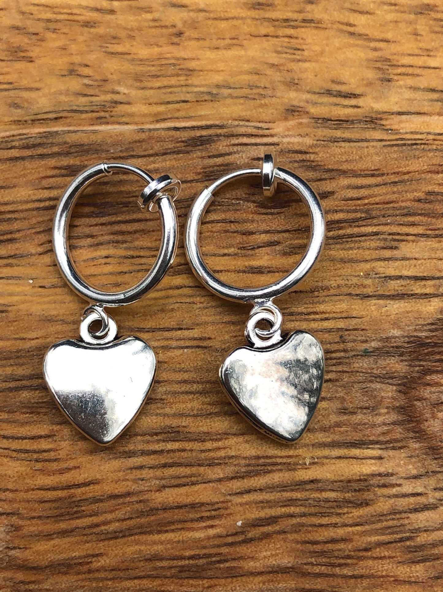 Silver coloured clip on earrings dangling charms on spring hoops (hearts, peace, fox, spider)