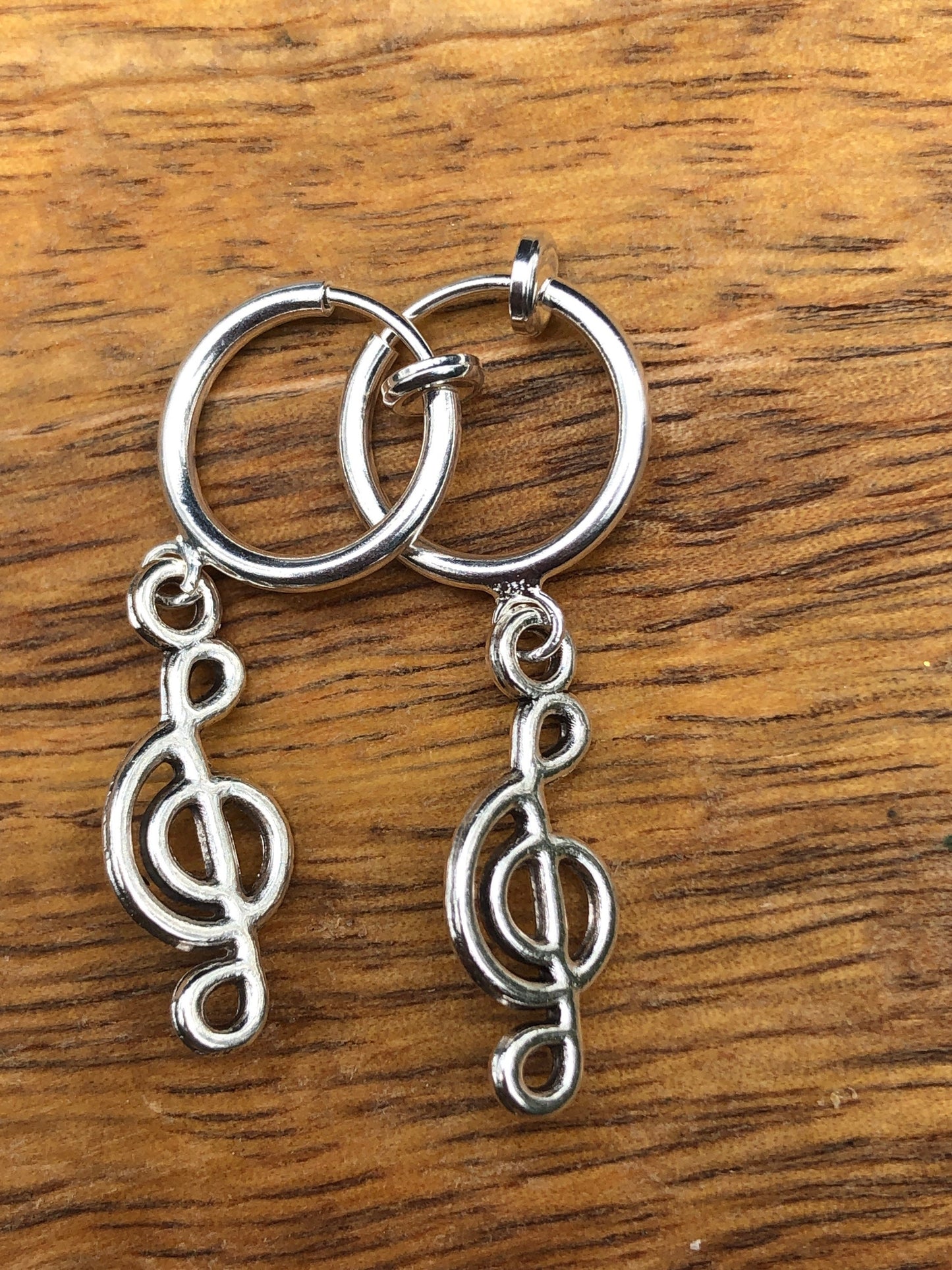 Silver coloured clip on earrings dangling charms on spring hoops (hearts, peace, fox, spider)