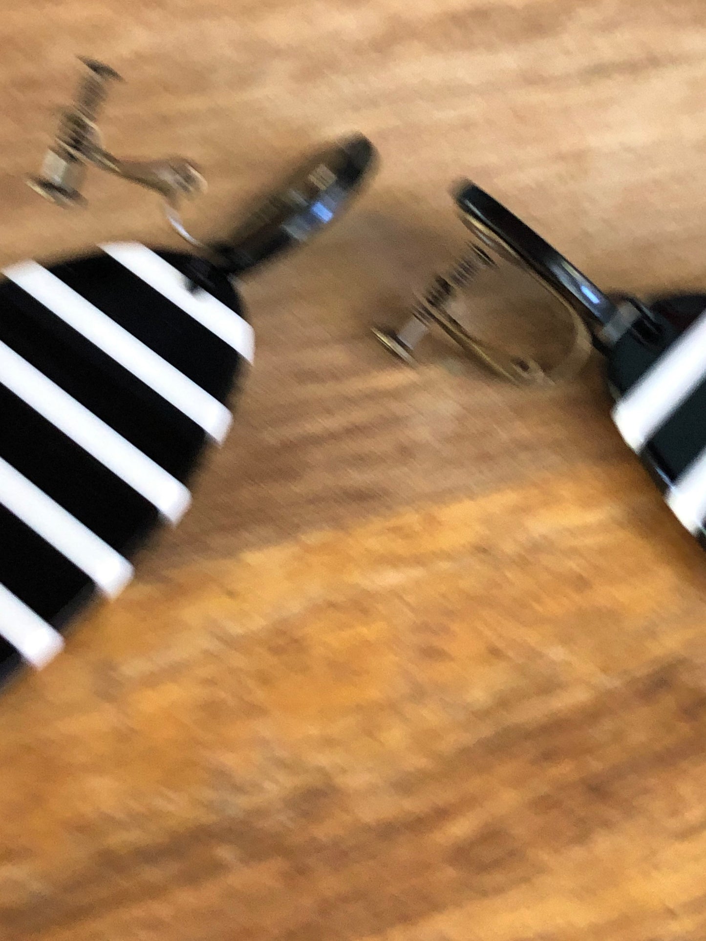 Oversized dangling black and white striped plastic oval clip on earrings