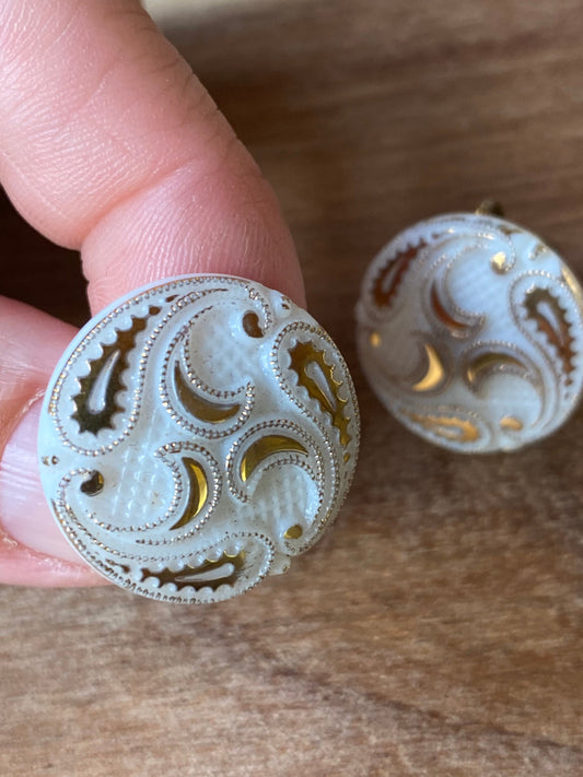 Vintage white plastic button clip on earrings with gold coloured paisley design