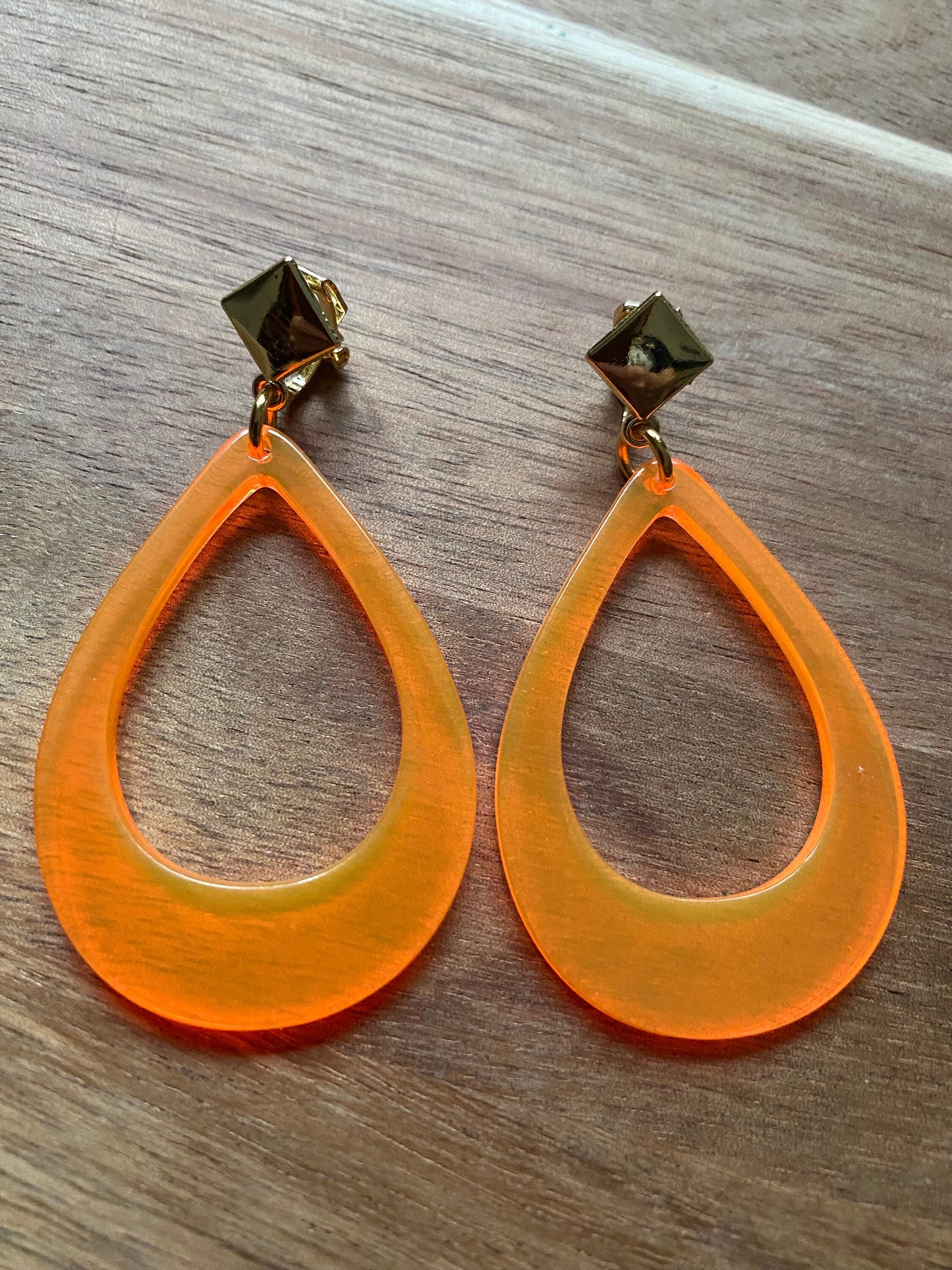 Vibrant retro neon dangling clip on hoop earrings in a teardrop shape with hinged screwback closures