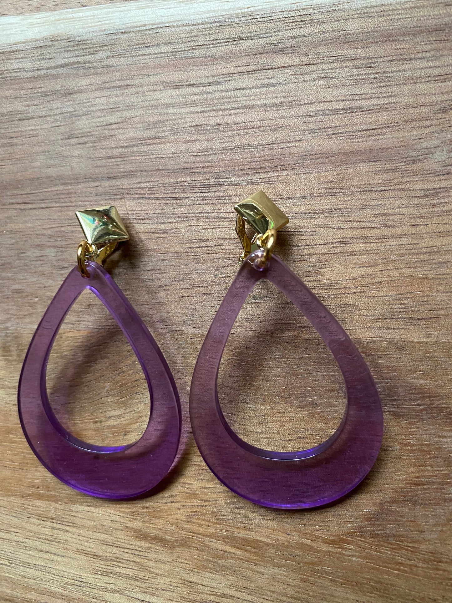 Vibrant retro neon dangling clip on hoop earrings in a teardrop shape with hinged screwback closures