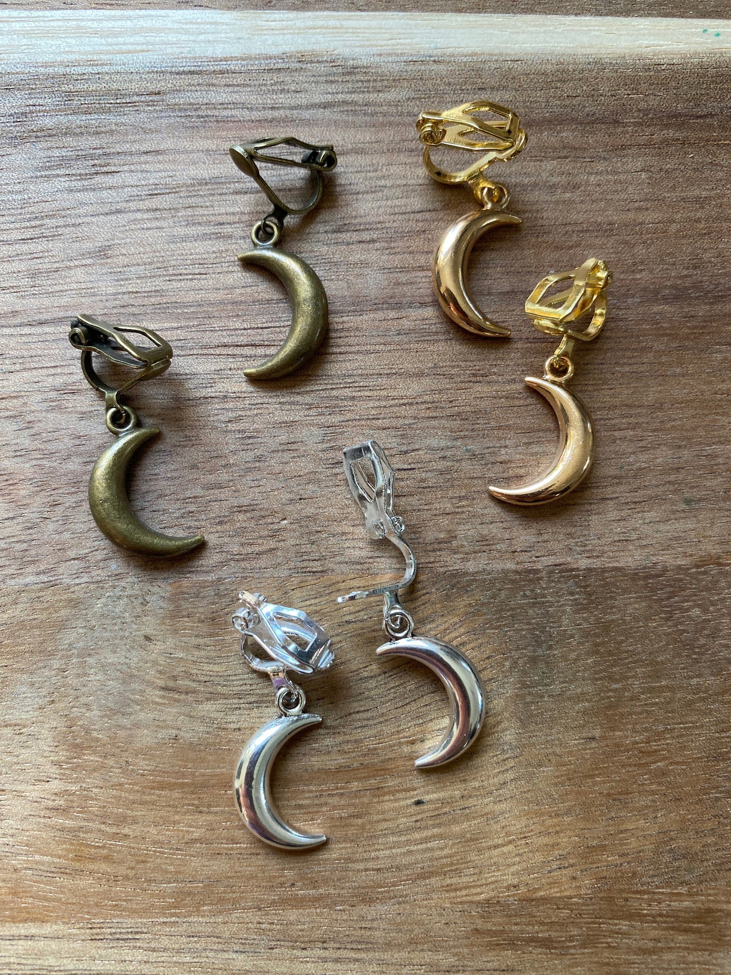 Dangling silver, bronze or gold coloured crescent moon spring hoop (huggie) or clip on earrings