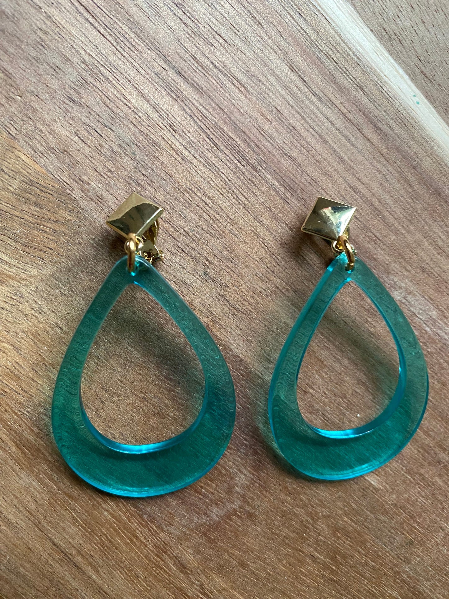 Vibrant retro neon dangling clip on hoop earrings in a teardrop shape with hinged screwback closures