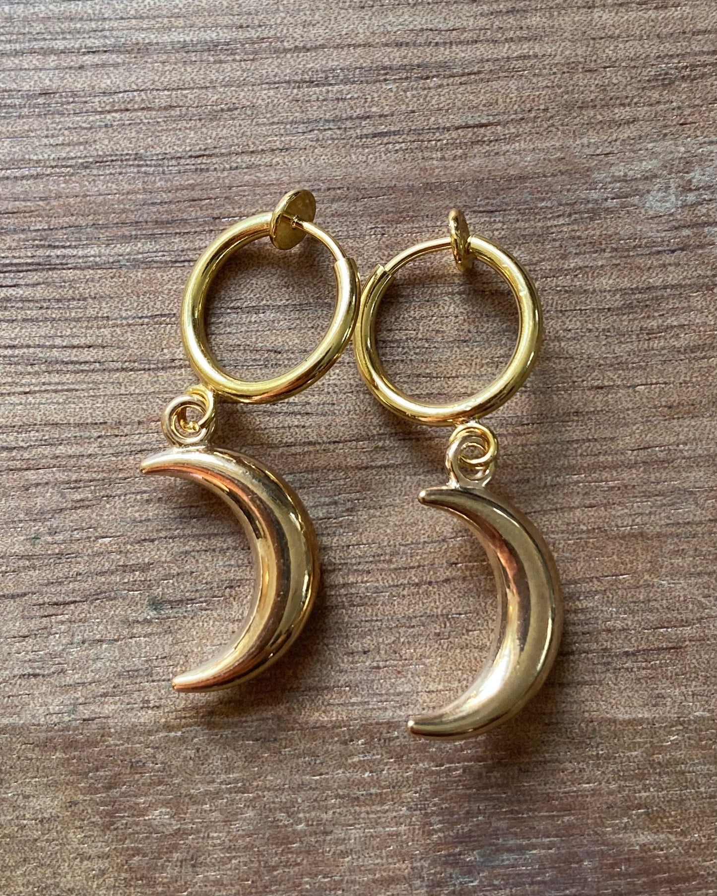 Dangling silver, bronze or gold coloured crescent moon spring hoop (huggie) or clip on earrings